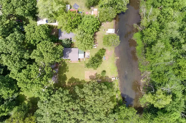 an aerial view of a house with a yard