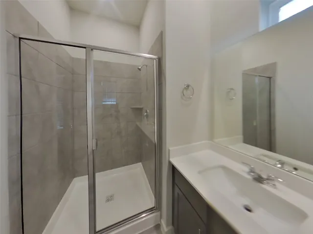 a bathroom with a shower and a sink