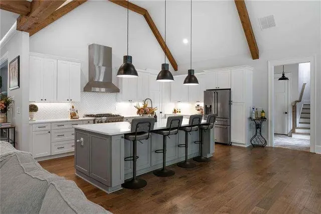 a kitchen with sink a stove and chairs