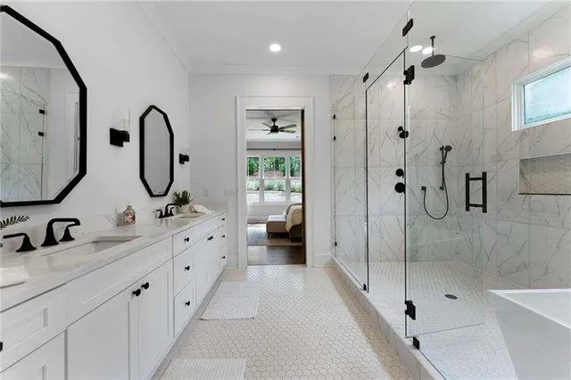a bathroom with double vanity sinks and a shower