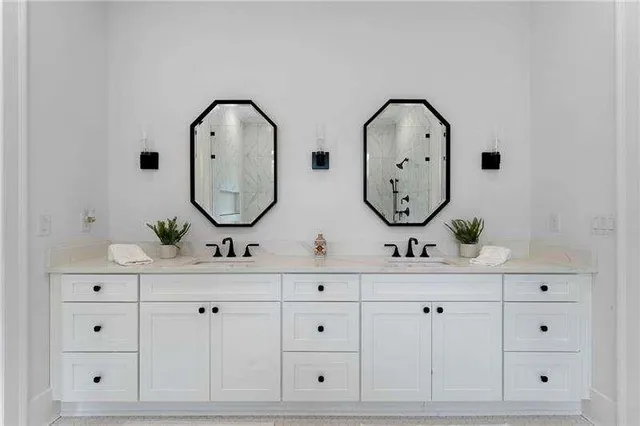a view of white cabinet with a sink and mirror