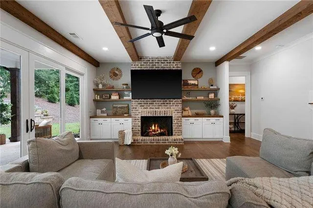 a living room with furniture a fireplace and a flat screen tv