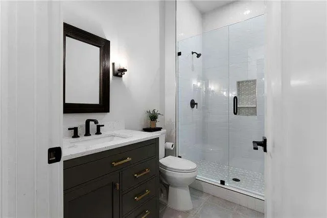 a bathroom with a toilet sink shower and mirror