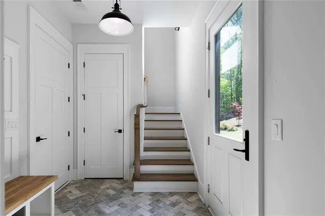 a view of a hallway with wooden floor and entryway