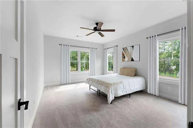 a spacious bedroom with a bed and a window