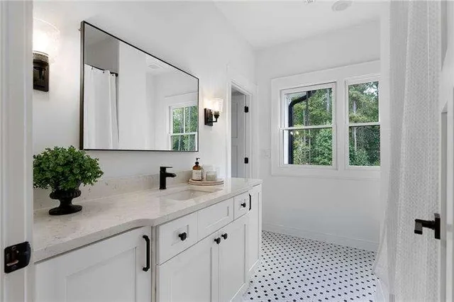 a bathroom with a sink a vanity and a mirror