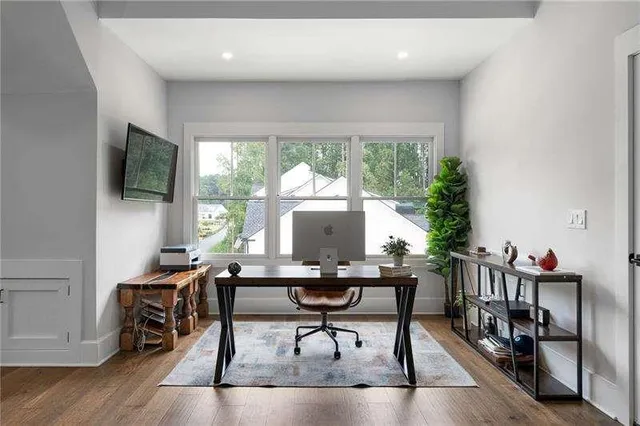 a workspace with wooden floor and a window