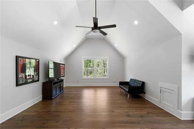 a view of a livingroom with furniture wooden floor and windows