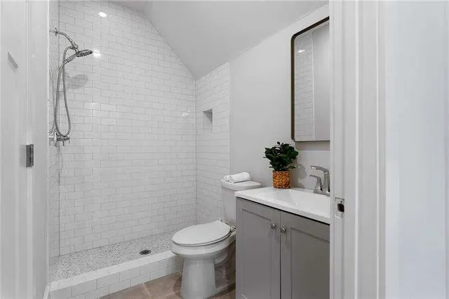 a bathroom with a sink a toilet and shower