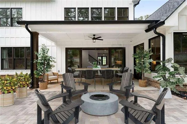 a view of a backyard with table and chairs under an umbrella
