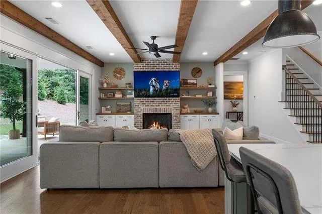 a living room with furniture a fireplace and a flat screen tv