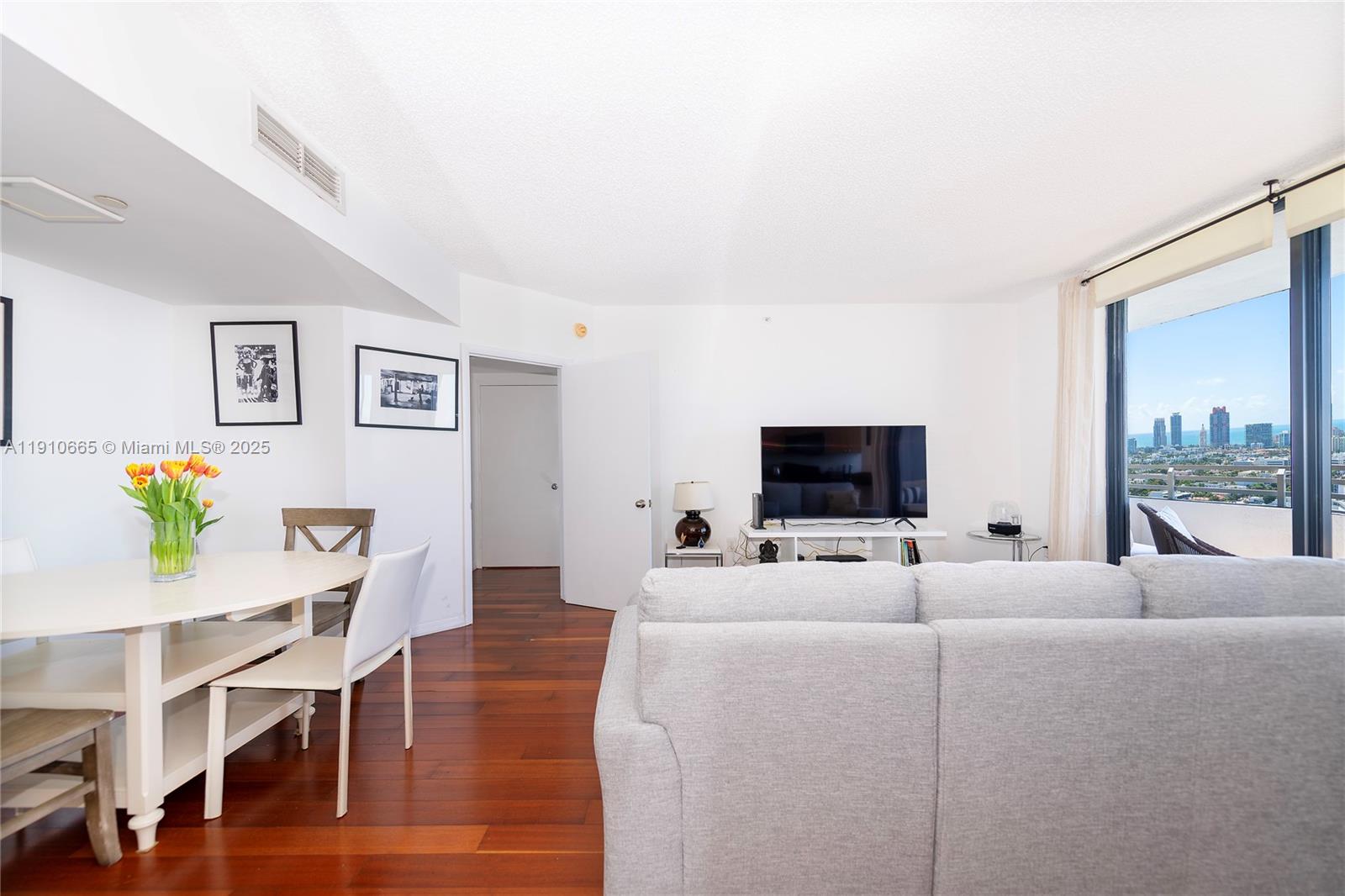 1330 West Avenue, Unit 3104 Miami Beach, FL 33139 - Photo 11 of 18 a living room with furniture and a flat screen tv