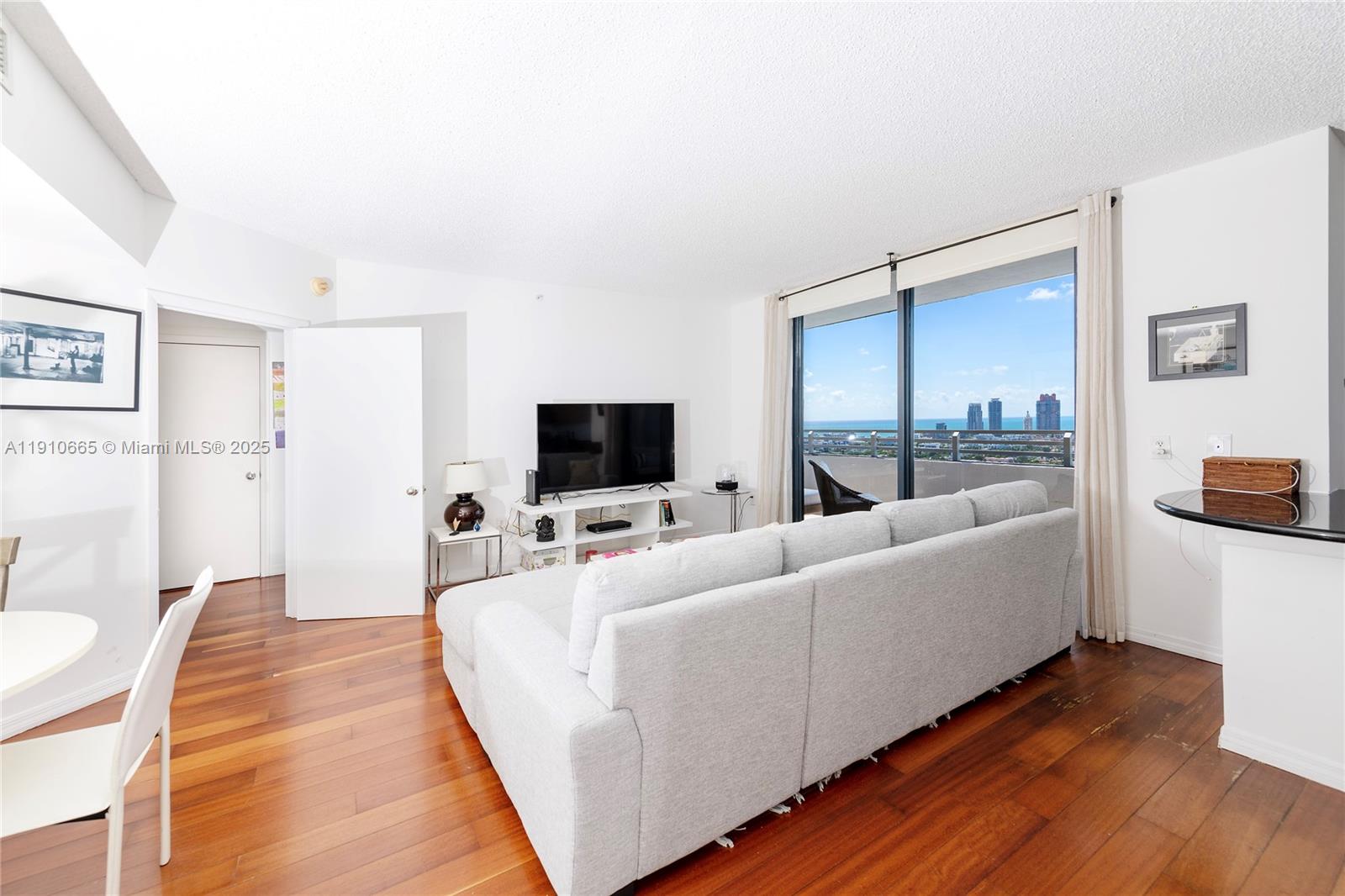 1330 West Avenue, Unit 3104 Miami Beach, FL 33139 - Photo 12 of 18 a living room with furniture and a flat screen tv