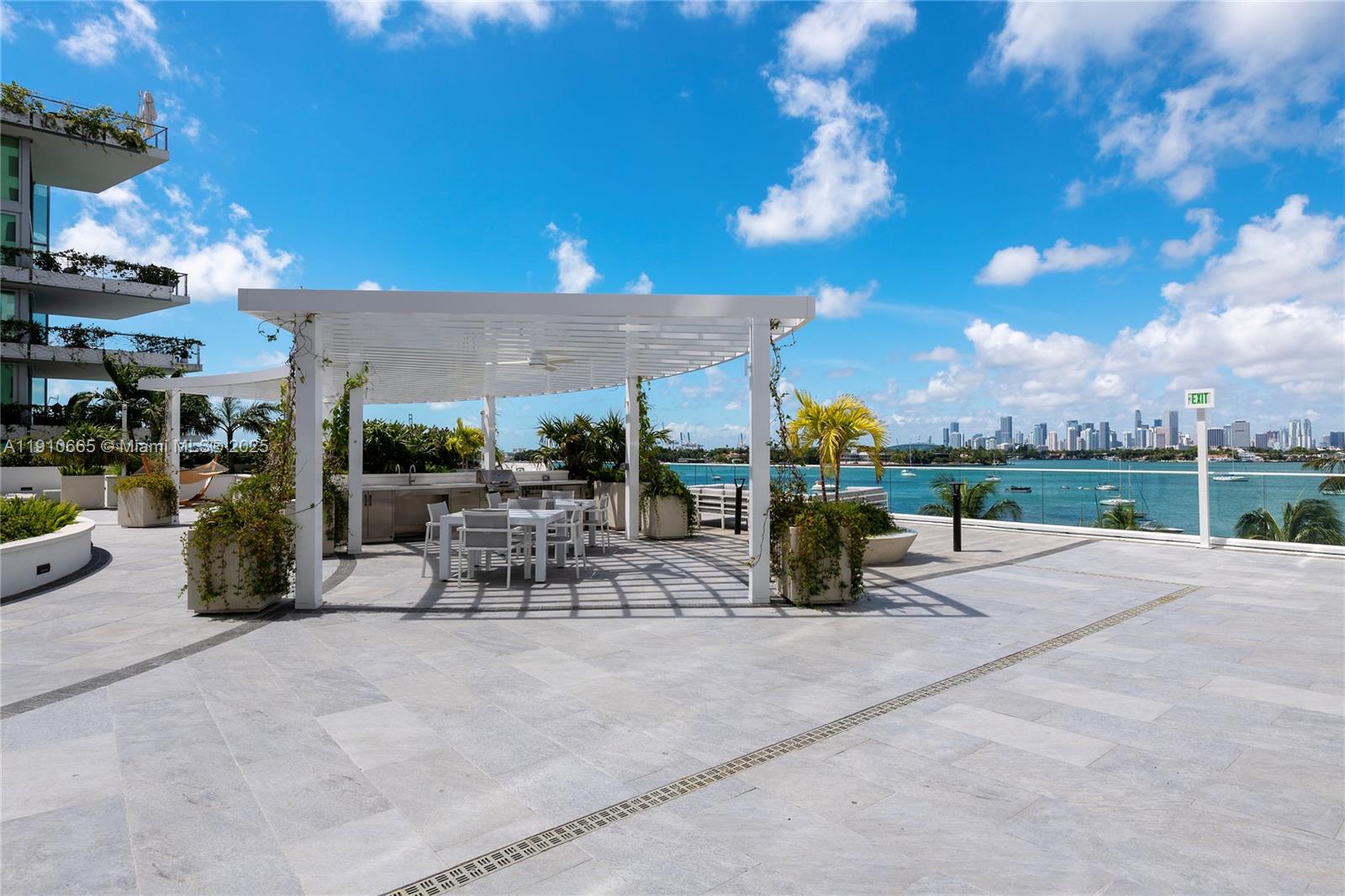 1330 West Avenue, Unit 3104 Miami Beach, FL 33139 - Photo 13 of 18 a view of a patio with a table and chairs under an umbrella