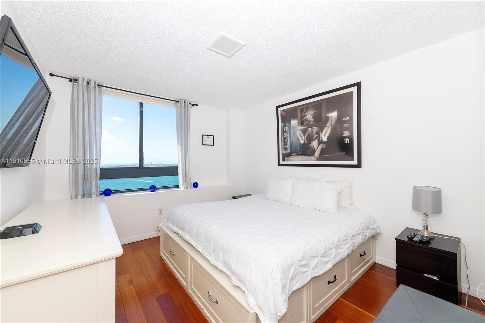 1330 West Avenue, Unit 3104 Miami Beach, FL 33139 - Photo 6 of 18 a bedroom with a bed and a flat screen tv