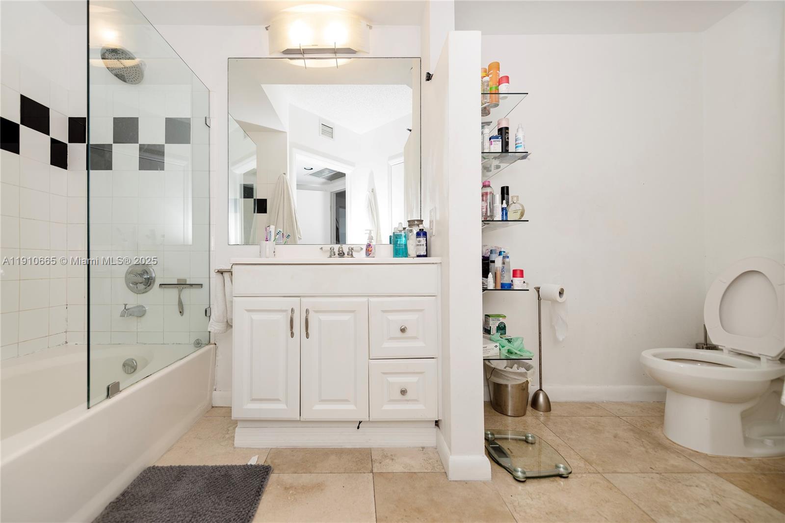 1330 West Avenue, Unit 3104 Miami Beach, FL 33139 - Photo 7 of 18 a bathroom with a sink a toilet and shower