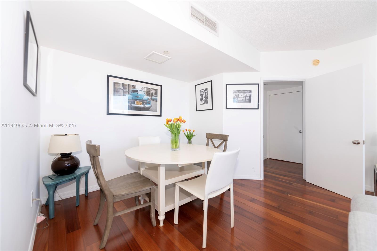 1330 West Avenue, Unit 3104 Miami Beach, FL 33139 - Photo 10 of 18 a view of a dining room with furniture and wooden floor
