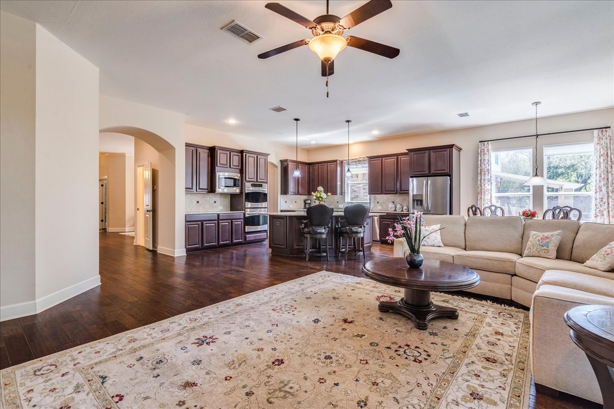 12909 Medina River Way Austin, TX 78732 - Photo 19 of 36 Amazing open concept main living area and adjacent kitchen, perfect for all of your entertaining needs.