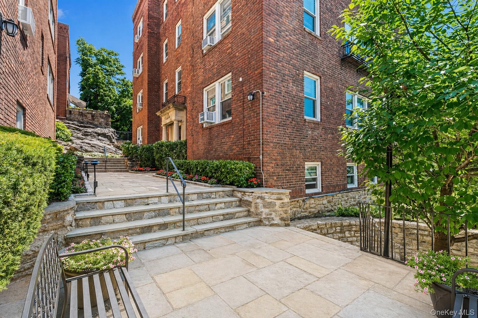 54 Sagamore Road, Unit 4E Bronxville, NY 10708 - Photo 1 of 10 a view of a brick building next to a yard