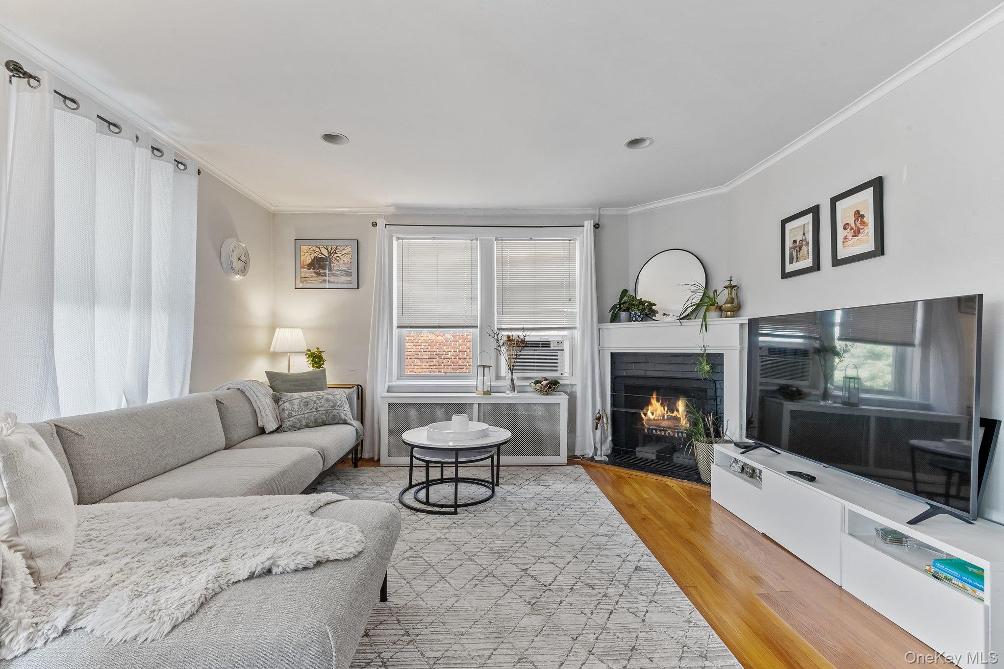 54 Sagamore Road, Unit 4E Bronxville, NY 10708 - Photo 3 of 10 a living room with furniture and a fireplace
