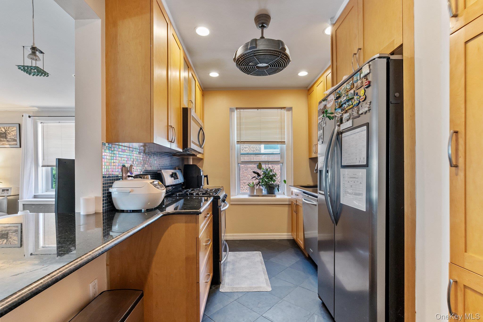 54 Sagamore Road, Unit 4E Bronxville, NY 10708 - Photo 6 of 10 a kitchen with a refrigerator a sink and cabinets