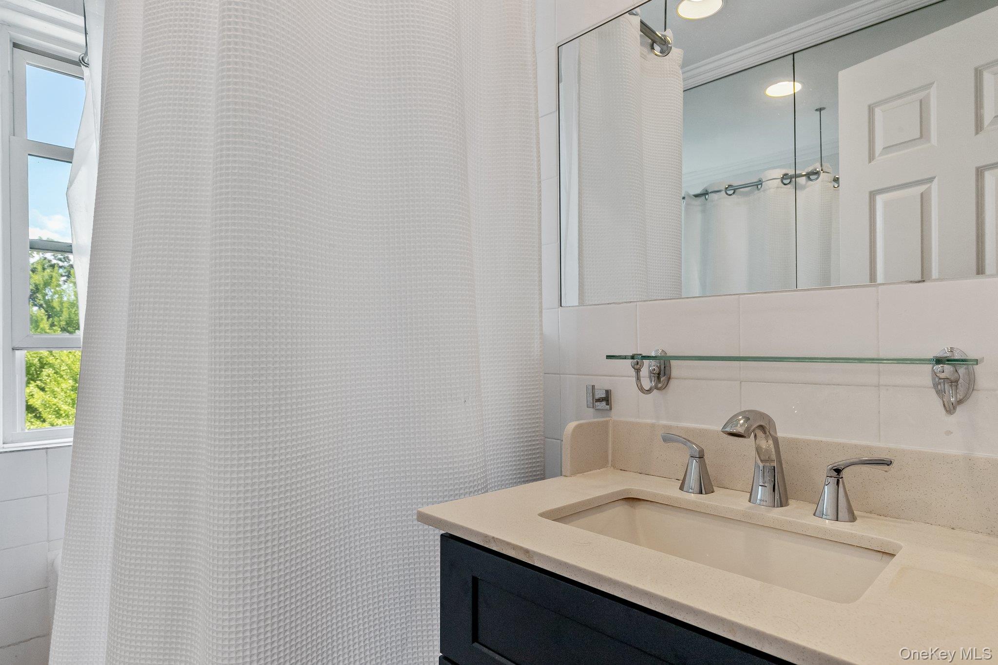 54 Sagamore Road, Unit 4E Bronxville, NY 10708 - Photo 9 of 10 a bathroom with a sink and a mirror