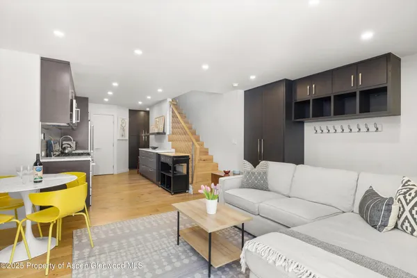 a living room with furniture and kitchen view