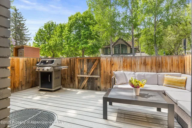 a view of a wooden deck with furniture