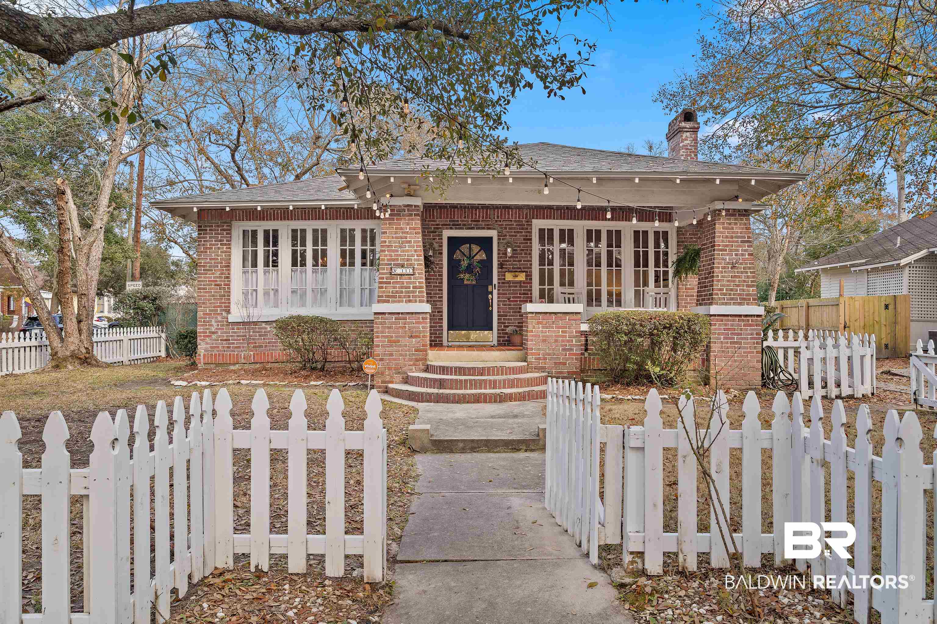 111 Macy Place Mobile, AL 36604 - Photo 1 of 35 View of front of home and white picket fence
