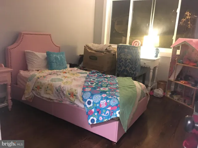 a bedroom with a bed and a lamp with window