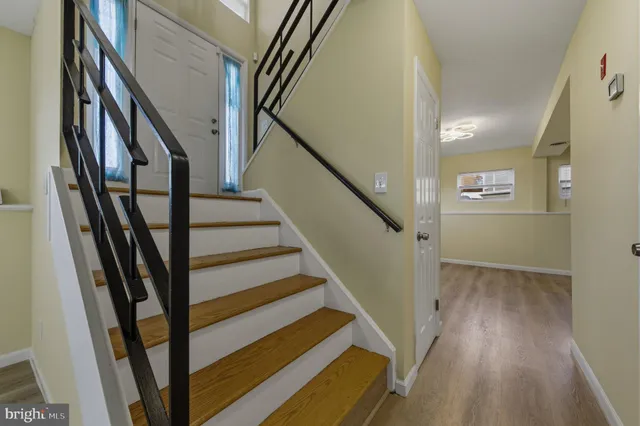 a view of entryway with wooden floor and stairs