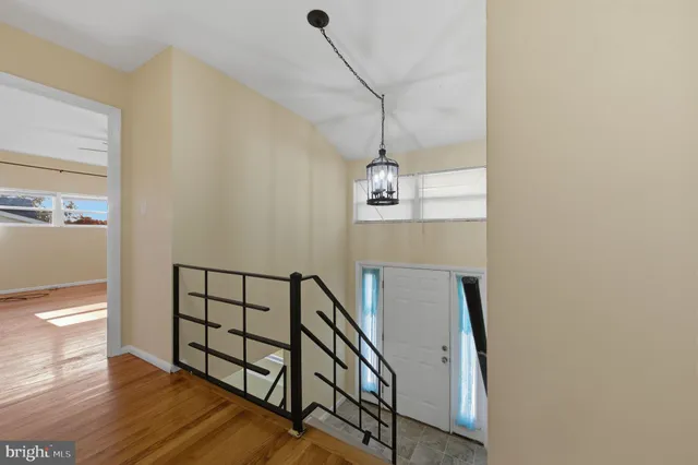 a view of entryway and hall with wooden floor