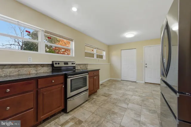 a kitchen with stainless steel appliances granite countertop a stove and a refrigerator