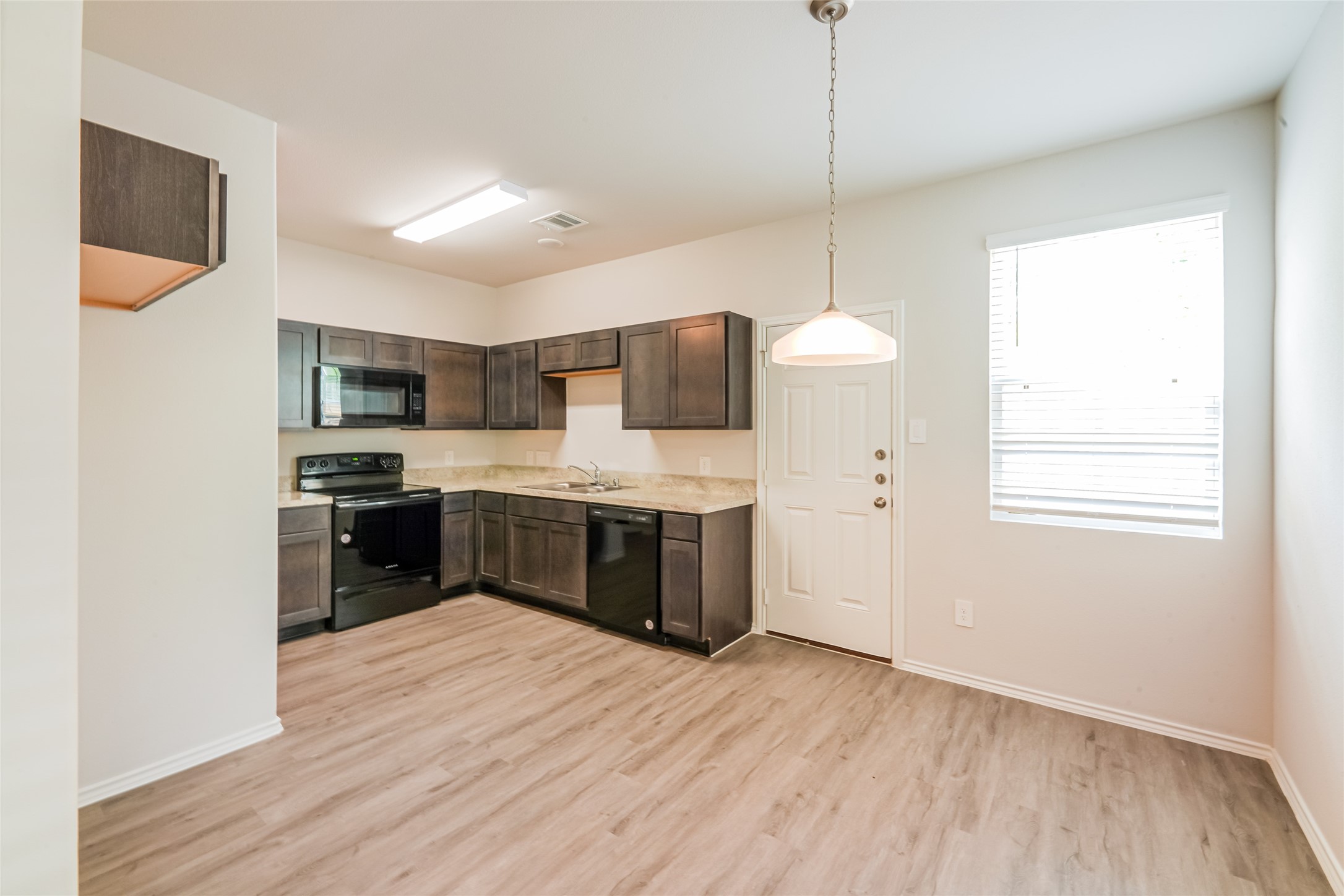 a kitchen with kitchen island a sink stainless steel appliances and counter space