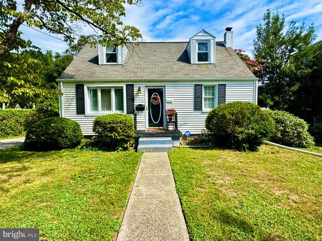a front view of a house with yard and green space