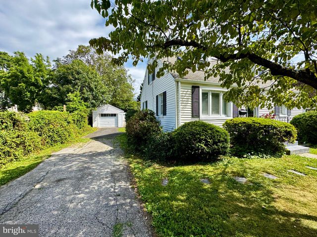 a front view of a house with a yard and outdoor seating
