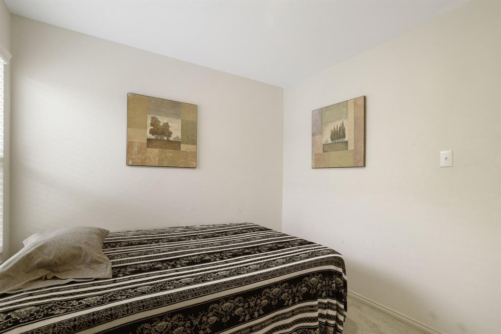 1445 Sterling Way Ferris, TX 75125 - Photo 13 of 17 a bedroom with a bed
