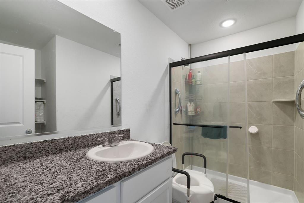 1445 Sterling Way Ferris, TX 75125 - Photo 8 of 17 a bathroom with a granite countertop sink and a mirror