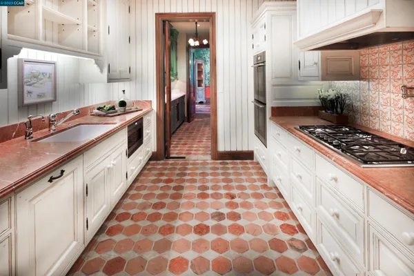 a kitchen with stainless steel appliances granite countertop a stove and cabinets