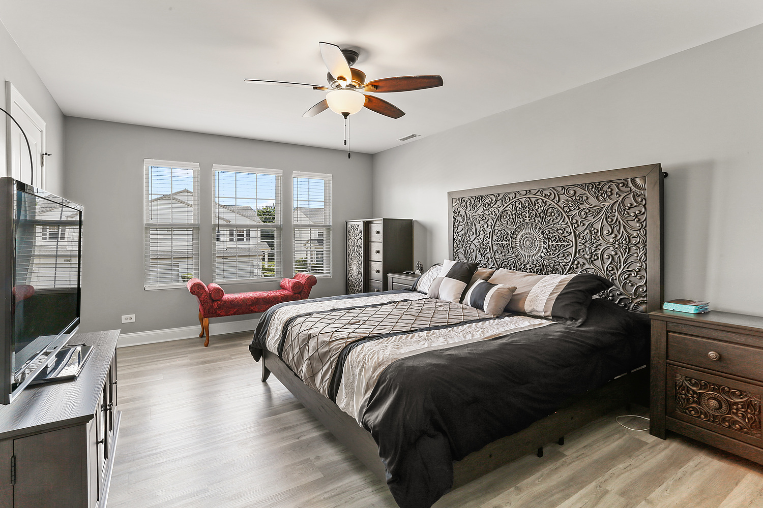 7007 Creekside Drive Plainfield, IL 60586 - Photo 18 of 21 a bedroom with a large bed and a chandelier