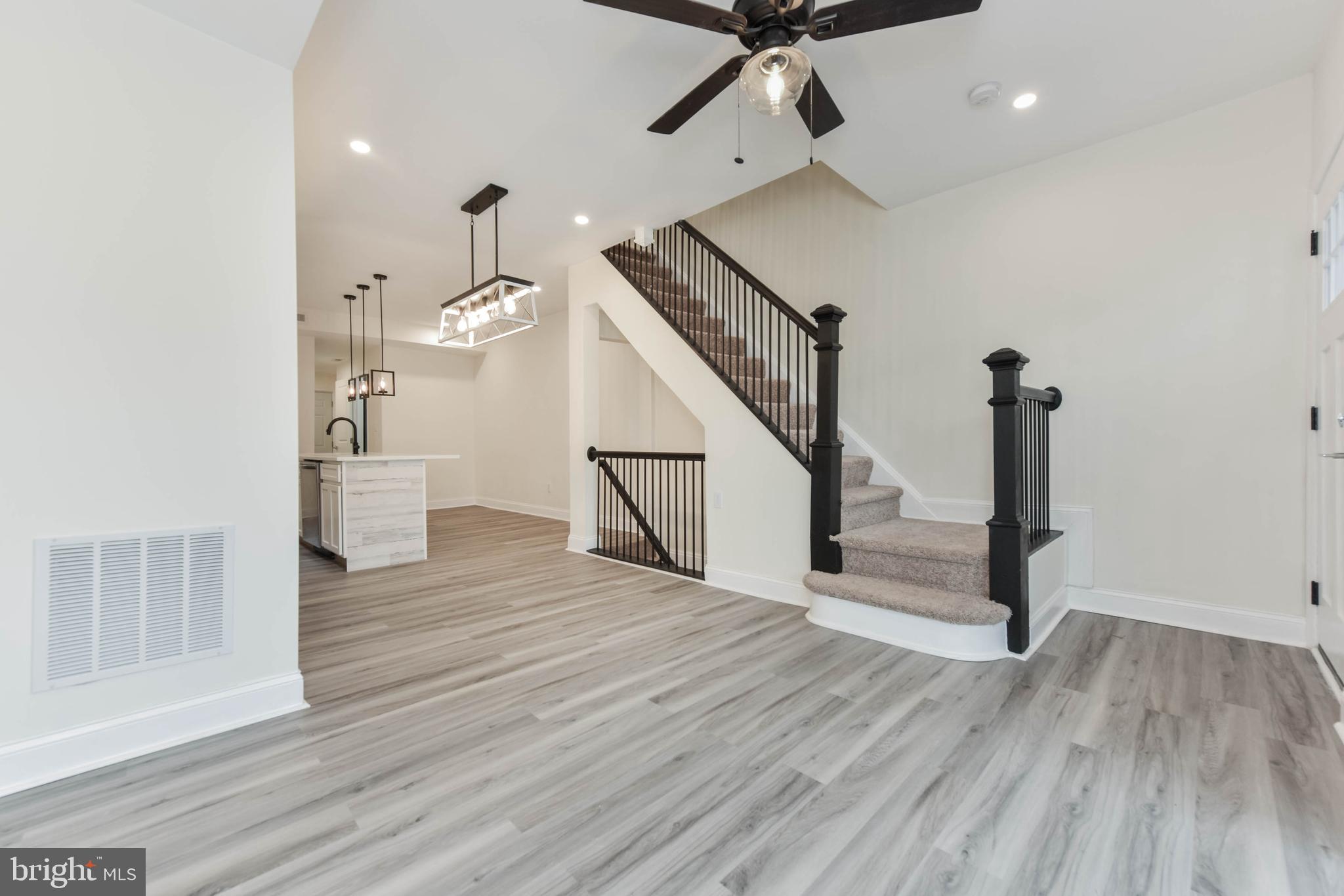 3108 Brighton Street Baltimore, MD 21216 - Photo 11 of 31 a view of a hallway with wooden floor and staircase