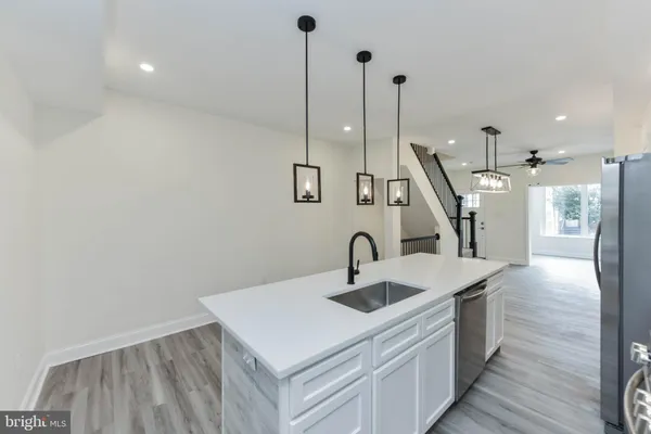 a kitchen with stainless steel appliances a refrigerator and a sink