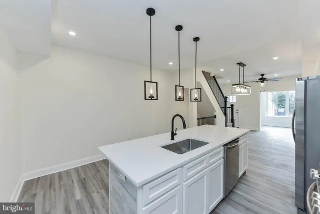 a kitchen with stainless steel appliances a refrigerator and a sink