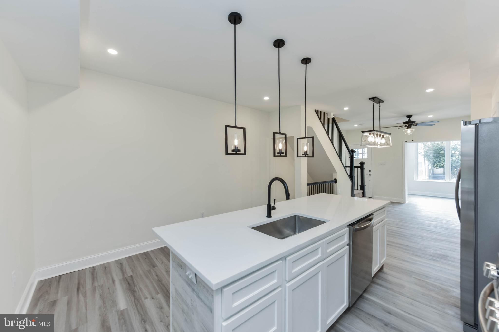 3108 Brighton Street Baltimore, MD 21216 - Photo 16 of 31 a kitchen with a sink a toilet and a sink