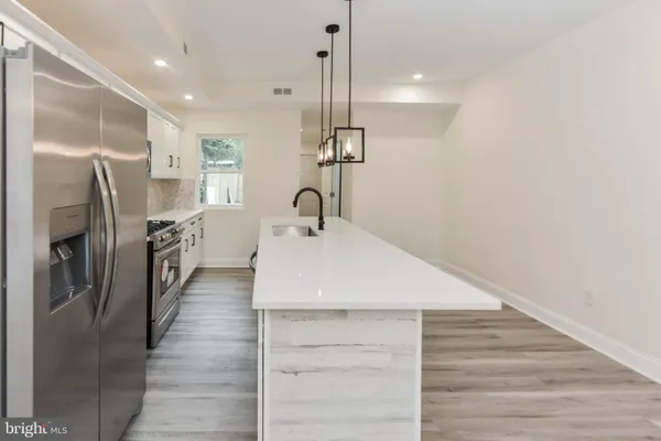 a dining room with wooden floor and stairs