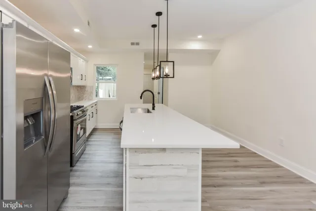 a dining room with wooden floor and stairs
