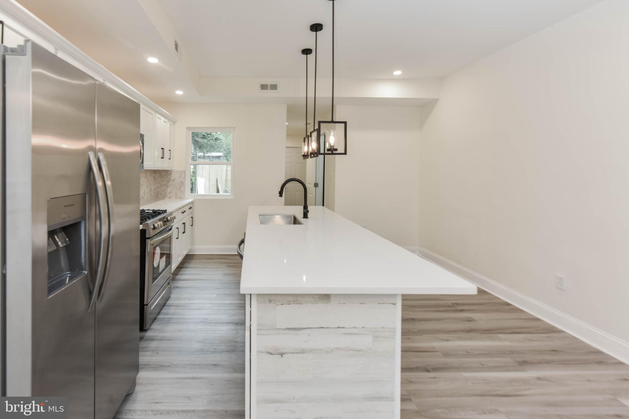 3108 Brighton Street Baltimore, MD 21216 - Photo 17 of 31 a kitchen with stainless steel appliances a refrigerator and a sink