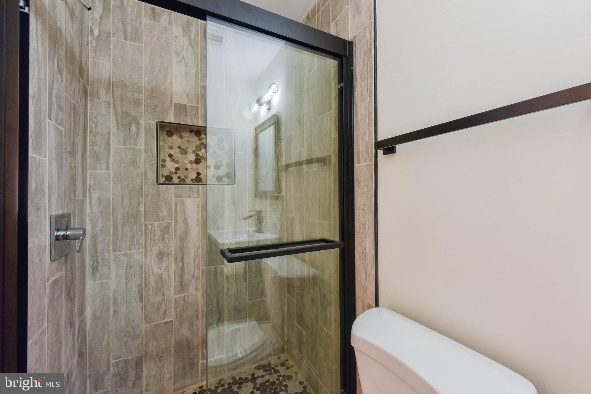 3108 Brighton Street Baltimore, MD 21216 - Photo 20 of 31 a bathroom with a shower and toilet