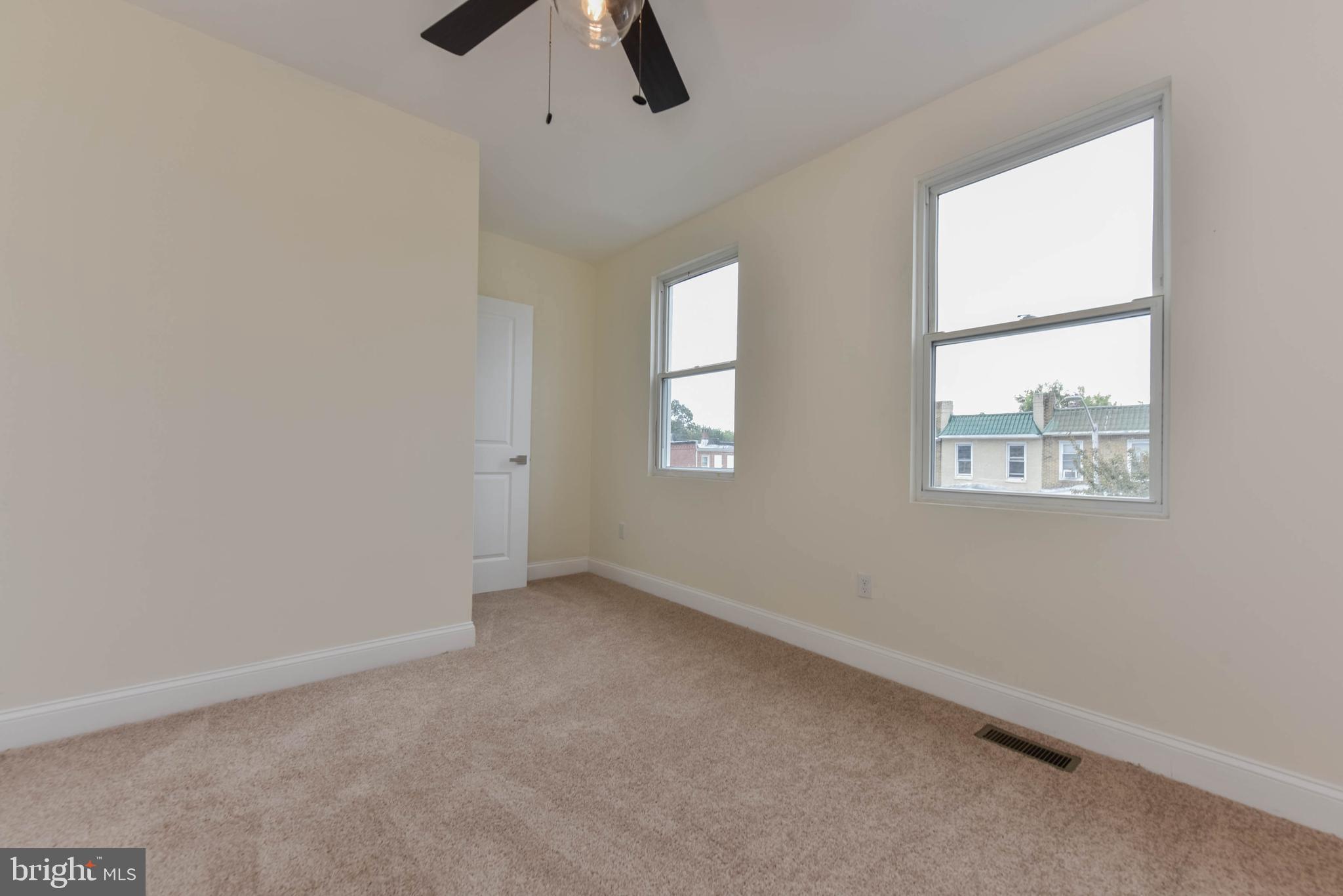 3108 Brighton Street Baltimore, MD 21216 - Photo 21 of 31 an empty room with windows