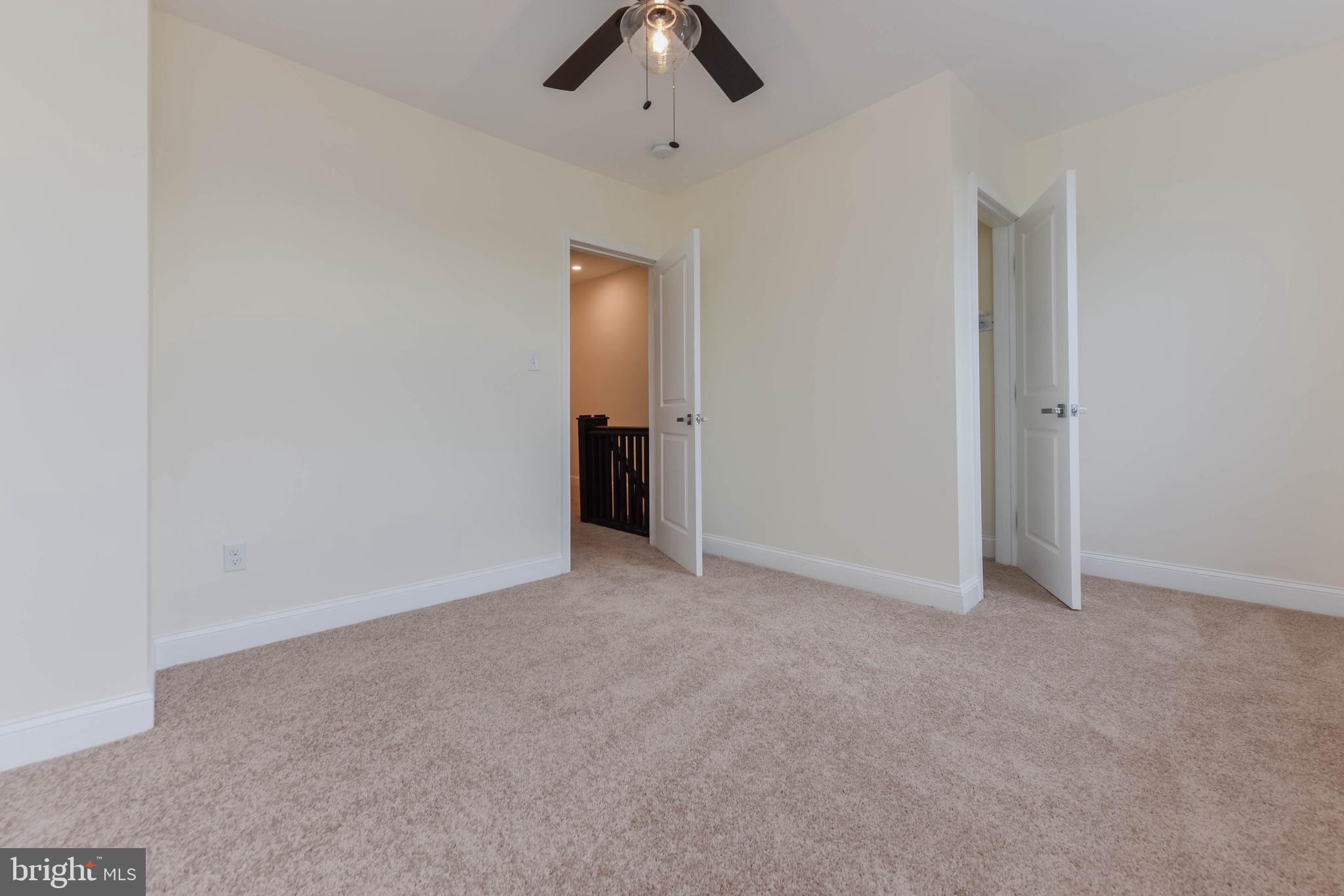 3108 Brighton Street Baltimore, MD 21216 - Photo 22 of 31 an empty room with chandelier fan